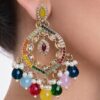 a colorful and golden earring on a model